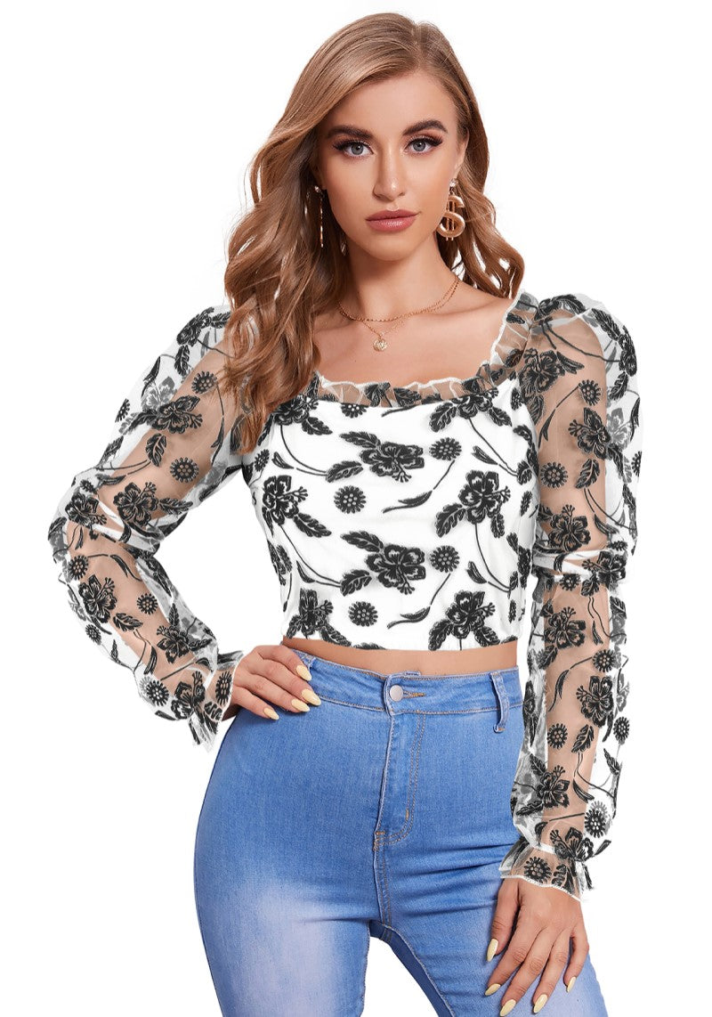 Model wearing pearl white floral crop top with sheer puff sleeves – front view.
