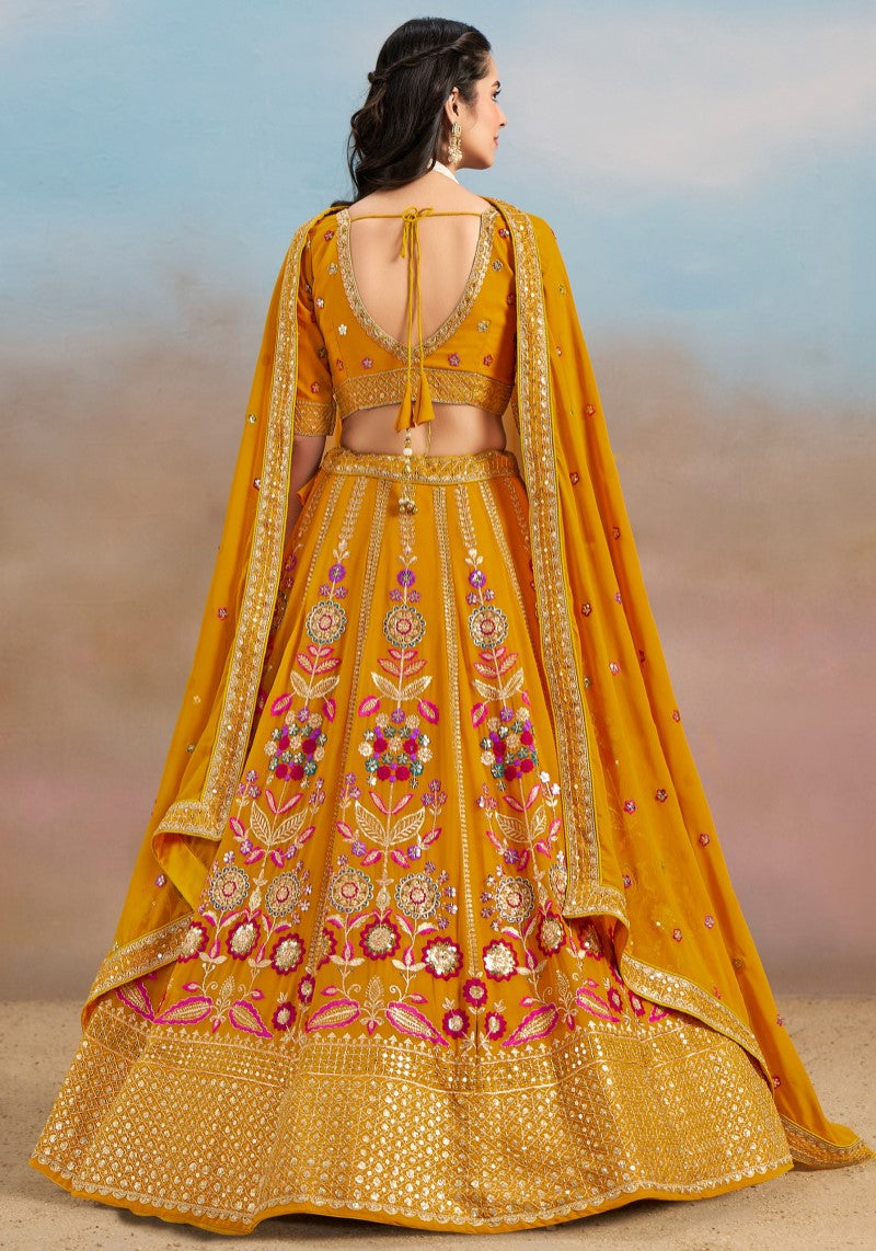 Back view of mustard yellow zari embroidered lehenga choli with resham floral detailing and scalloped neckline