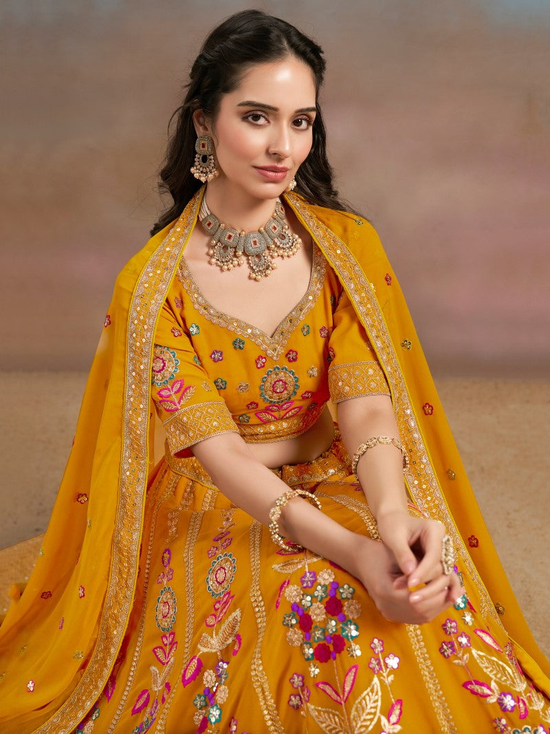 Sitting close-up of model in Mustard Yellow Floral Zari Embroidered Lehenga Choli