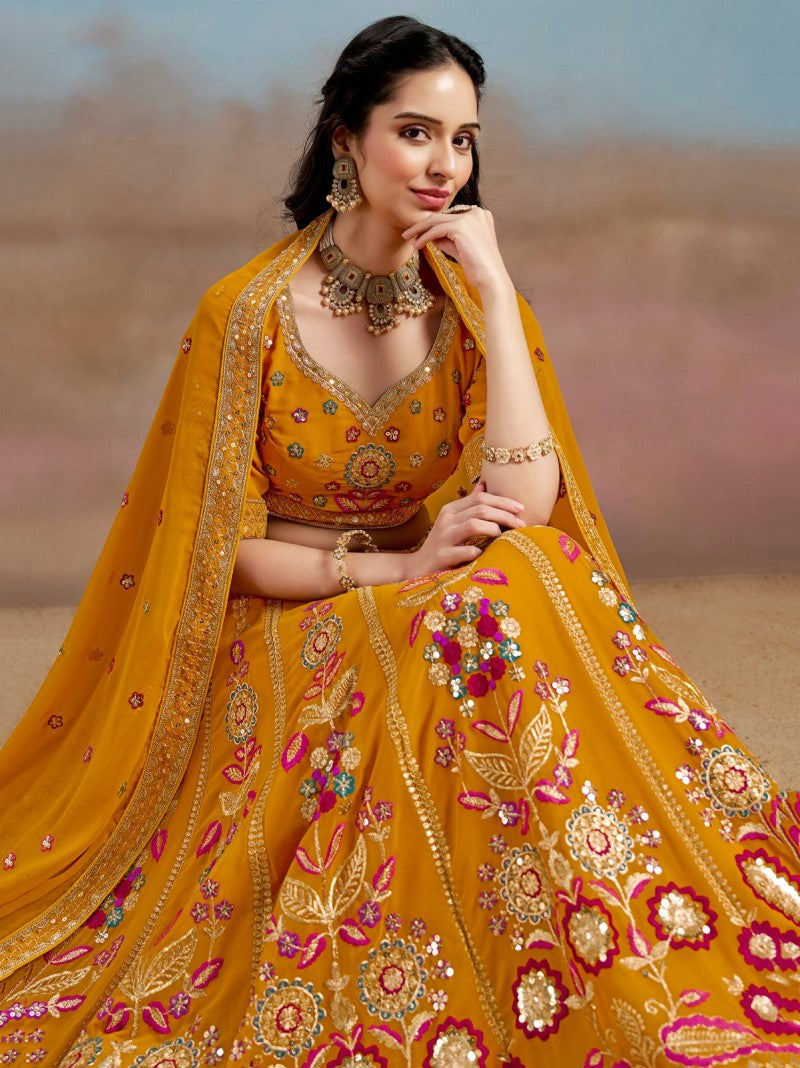 Sitting close-up of model in traditional Mustard Yellow Floral Zari Embroidered Lehenga Choli- A royal ethnic ensemble for a wedding occasion