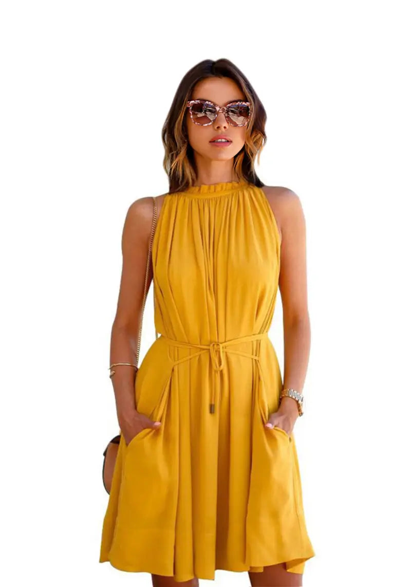 Close view of the model wearing "Yellow Western Halter Neck Pleated Short Dress" featuring sleeveless pleated mock neck dress with pocket s for a stylish look.