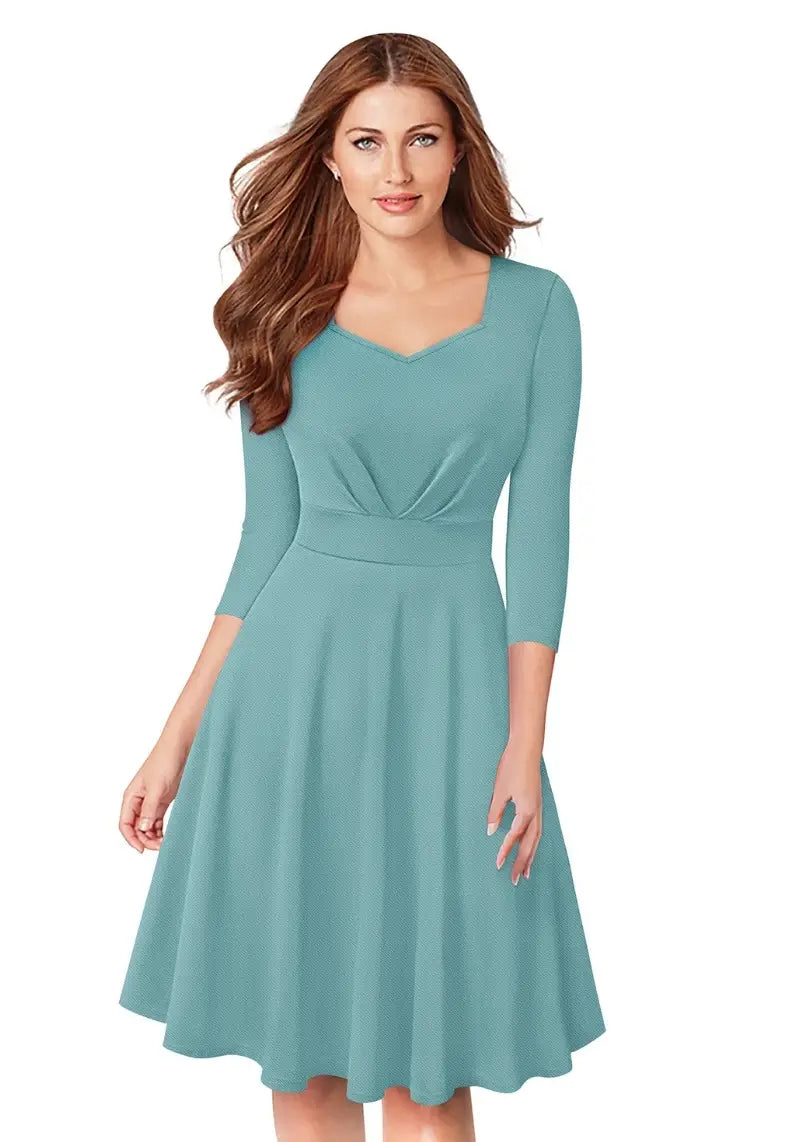Model wearing Chic Pista Fit & Flare Flounce Hem Dress with diamond neckline and 3/4 sleeves, posing front-facing.