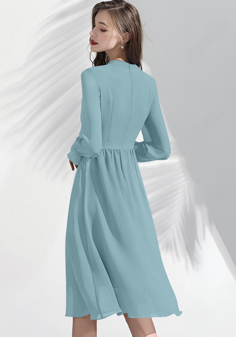 Back view of Pista midi dress with subtle pleats and clean back panel for a refined look.