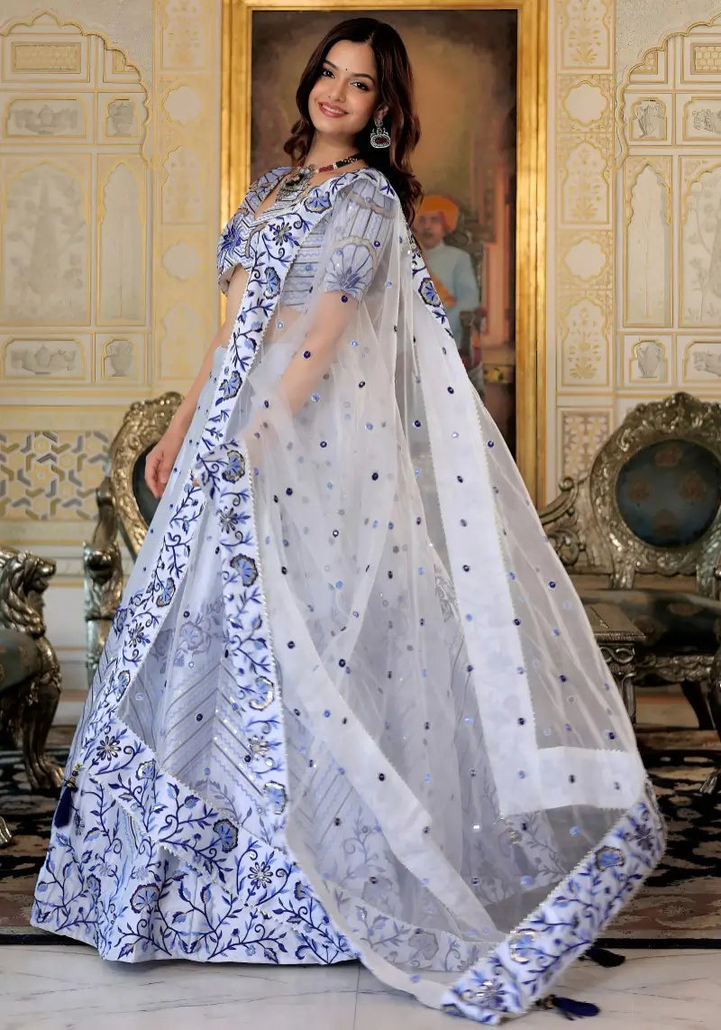 Left side pose of model in White and Blue Heritage Lehenga Choli with dupatta Set with satin embroidery.