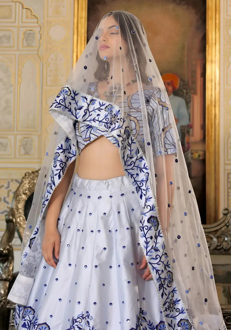 Close-up of embroidery on White and Blue Heritage Lehenga Choli with dupatta Set worn by model.