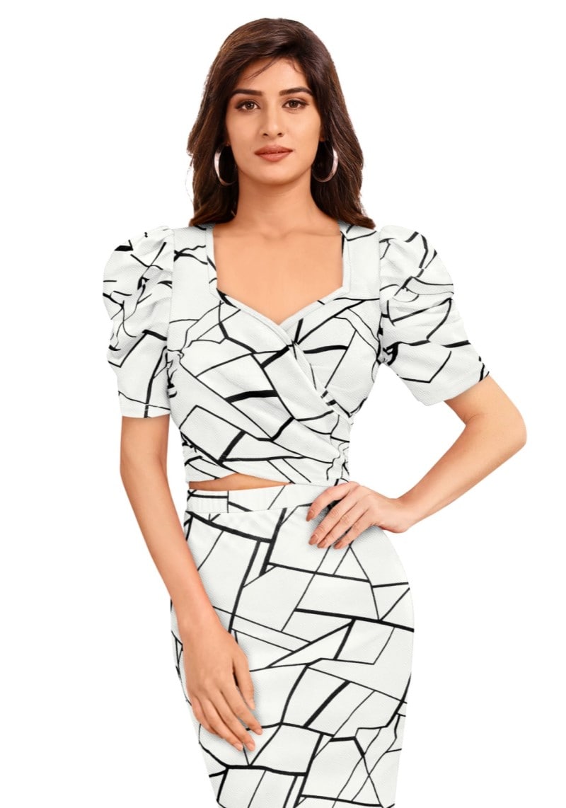 Close view of the model wearing a white geometric print puff sleeved top and skirt with top having sweet heart neckline and a elegnt geometric print all over the set.