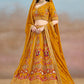 Left side view of mustard yellow lehenga choli with intricate floral zari embroidery and elegant flare design