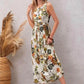 Left Side profile of model in Tropical Bloom White Floral Sleeveless Midi Dress