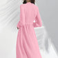 Model showing back of Peach ruffle midi dress with defined waist and flared hem.