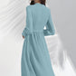 Back view of Pista midi dress with subtle pleats and clean back panel for a refined look.