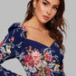 Close up of Floral print sweetheart neck puff sleeve midi bodycon dress in elegant blue variant