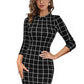 A woman wearing a black checkered bodycon dress with a round neck and 3/4 sleeves.