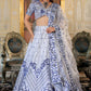 Right side pose of model in White and Blue Heritage Lehenga Choli with dupatta Set with satin embroidery.