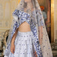 Close-up of embroidery on White and Blue Heritage Lehenga Choli with dupatta Set worn by model.
