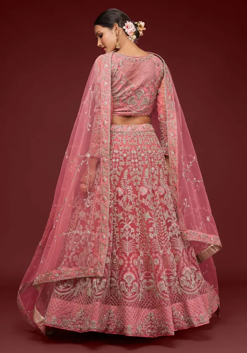 Back view of the model wearing Fantasy Rose soft net lehenga choli set with detailed embroidery and matching dupatta.