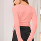 Back view of model in peach ruched drawstring crop top with full sleeves