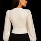 Back view of Snazzyhunt white V-neck buttoned corset top showing structured waist and long puff sleeves.