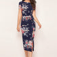 Front view of the model wearing Enticing Blue Floral Printed Side-Slit Bodycon Dress with short sleeves and a round neckline.