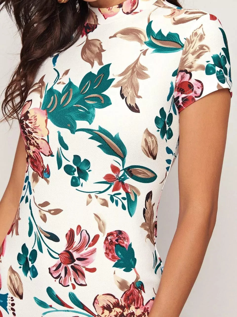 Close profile of model in Ivory Bloom Floral Bodycon Dress highlighting the curve-hugging fit, mock neckline, and elegant floral pattern.